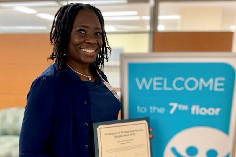 female nurse holding certificate