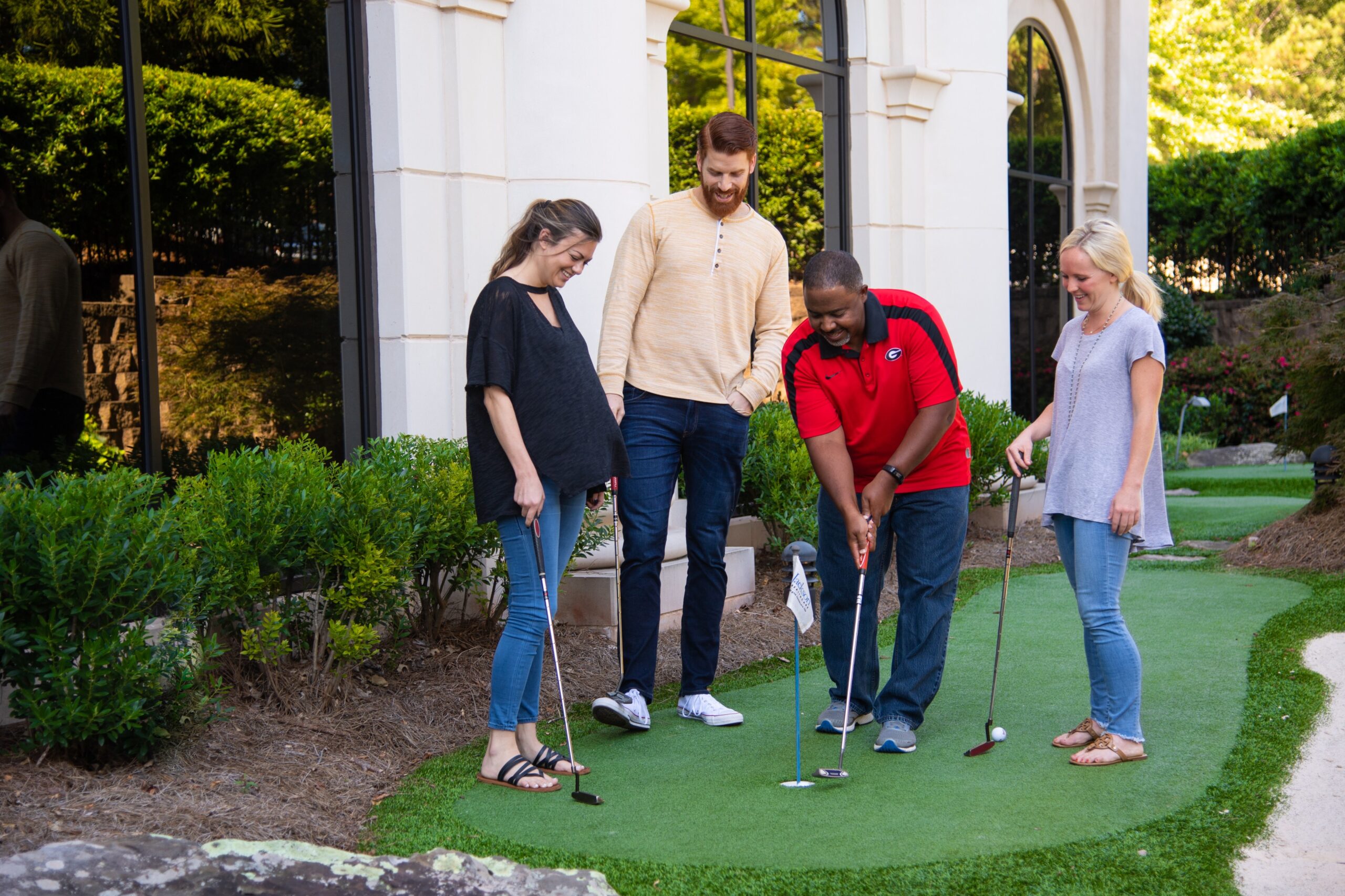 group of adults playing mini golf