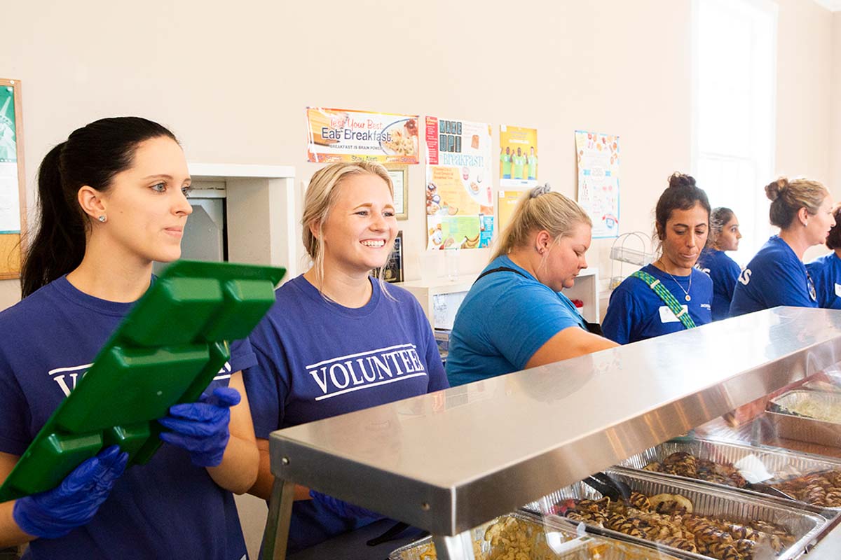 Coworkers volunteering their time serving food